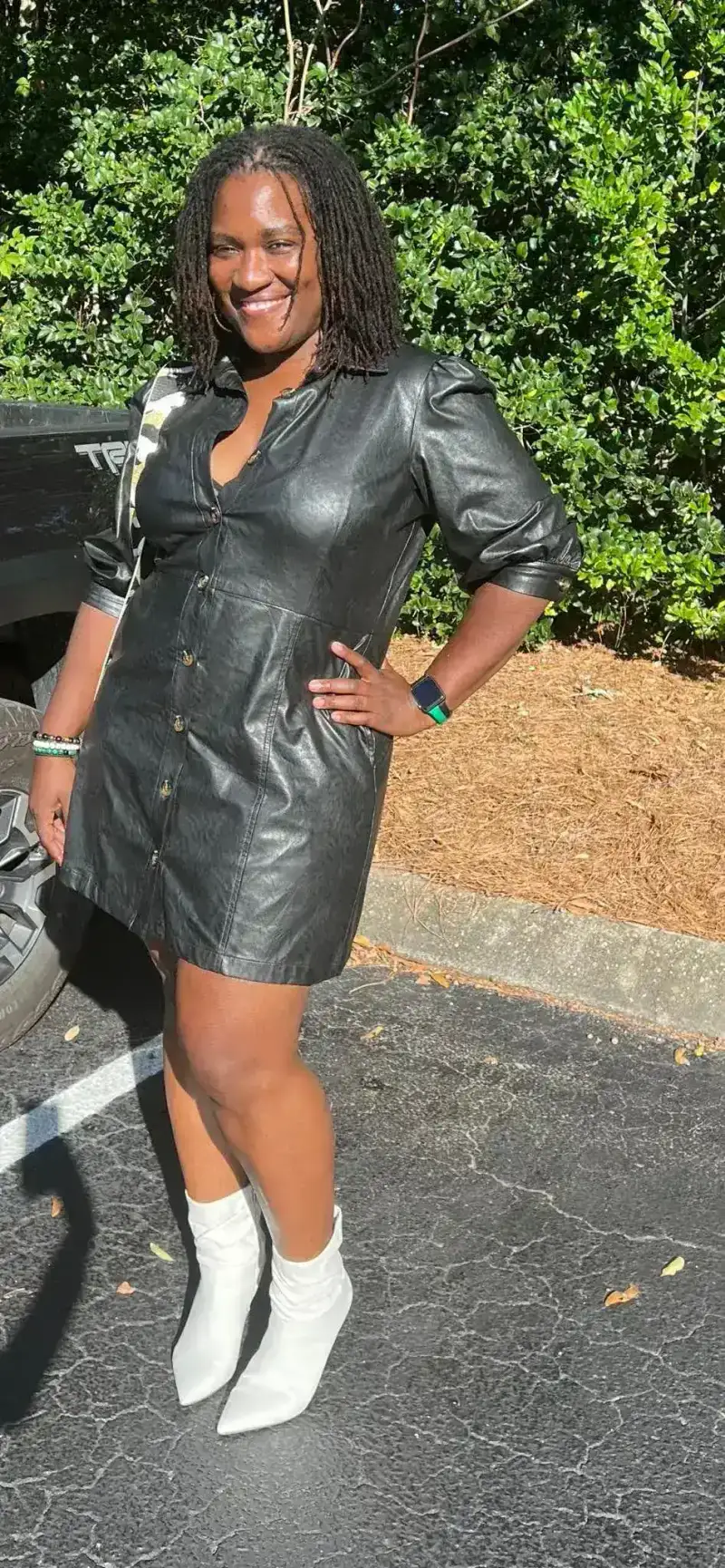 Black leather shirt dress and white pointed boots