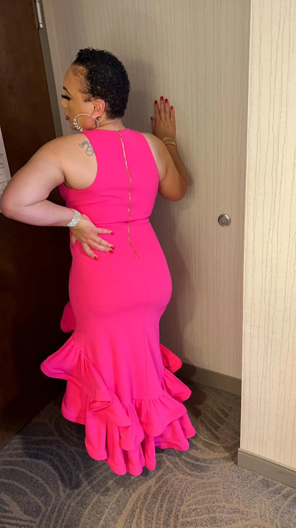 Hot-pink ruffle mermaid gown styled with metallic heels